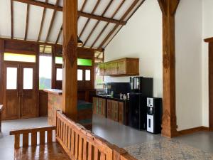 Habitación grande con cocina con vigas de madera. en Villa Sophie Lombok, en Mataram
