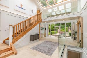 a glass staircase in a house with a skylight at Skyfall in Prestbury