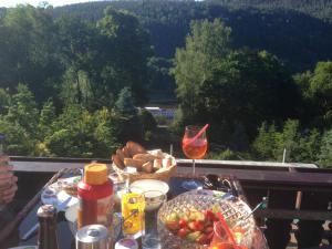 a table with a bowl of food and a glass of wine at Ferienwohnung 1 Festungsblick in Königstein an der Elbe