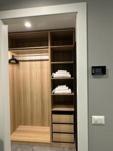 a walk in closet with wooden cabinets and towels at Alla Casa Di Giò in Milan