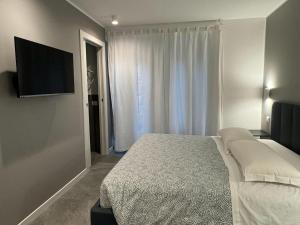 a bedroom with a bed and a flat screen tv at Alla Casa Di Giò in Milan