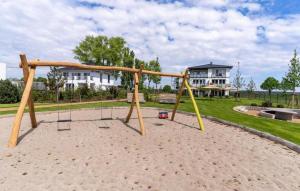 a playground with a swing in a park at Haffhaus 1 in Garz mit Blick auf das Haff in Zirchow