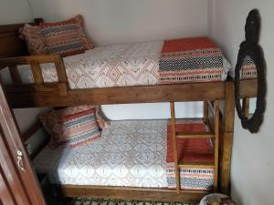 a room with two bunk beds and a staircase at Hotel Posada Turística la Ceiba in Vergara