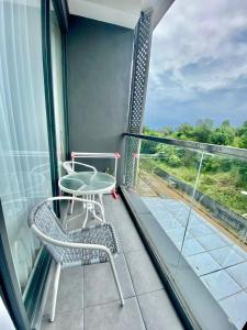 a balcony with two chairs and a table at Skylounge Balikpapan by Wika Realty in Sepinggang-besar