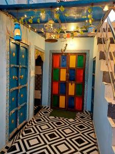 a room with colorful doors and a tiled floor at The Mehran way Homestay in Jodhpur