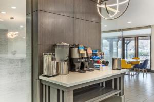 a kitchen with a counter with a coffee maker on it at Comfort Inn & Suites Irving Las Colinas DFW in Irving