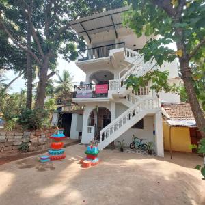 a building with a staircase in front of it at Riverside, The European Homestay 1 and 2! Luxury and Value in Goa's delightful location in Agarvado