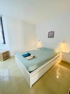 a bedroom with a bed in a white room at Sunlight apartment in Costa de Antigua in Costa de Antigua