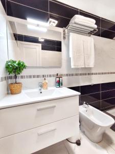 a white bathroom with a sink and a toilet at Sunshine Escape with ocean view in Adeje