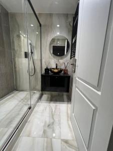 a white bathroom with a shower and a sink at Villa de luxe JO 2024 in Saint-Brice-sous-Forêt