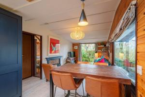a dining room with a wooden table and chairs at Dock Tarn Lodge in Ambleside