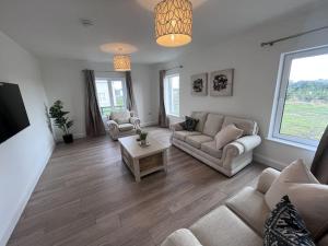 a living room with a couch and a table at Modern Dunboyne Home in Dunboyne