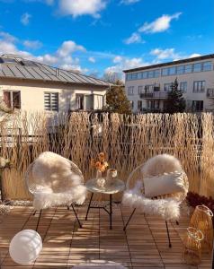 dwa krzesła i stół na patio w obiekcie AMALFI HOME - Stylish apartment with terrace w Schonefeld