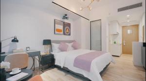 Una cama o camas en una habitación de Golden Central Hotel Serviced Residence-Xin Hao E Du金中环服务公寓新浩e都店