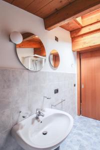 a bathroom with a white sink and a mirror at Appartamento Al Porto in Pianello Del Lario