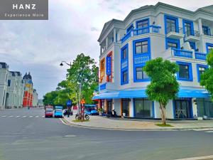 a blue and white building on the corner of a street at HANZ Sofia Hotel Grand World in Phu Quoc