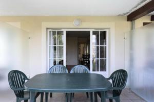 a blue table and chairs on a patio at Le meilleur des Belles Rives Immozen46 in Argentat