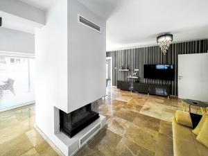 a living room with a fireplace and a tv at Magnificent Villa with Private Pool in Girne in Kyrenia