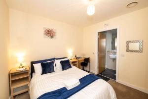 a bedroom with a bed and a desk and a sink at Grand Central , 2 double bedroom apartment with free parking , Birmingham in Birmingham