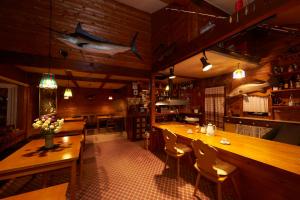 ein Restaurant mit einer Bar mit einem Fisch an der Wand in der Unterkunft Lake village donaludo Pension in Kitashiobara