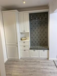 a large white cabinet in the corner of a room at Apartament Areni Suceava in Suceava