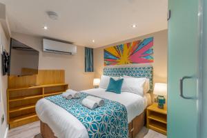 A bed or beds in a room at The Old School House - Luxury Themed Apartments