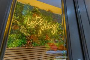 a window with the words vacation play written on it at The Old School House - Luxury Themed Apartments in Nottingham