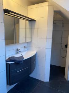 a bathroom with a sink and a mirror at Ferienwohnung Weberschläger in Ulrichsberg