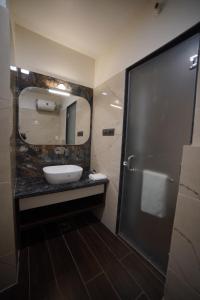 a bathroom with a sink and a mirror at Hotel 777, Pushkar By Shivaneel Hospitality in Pushkar