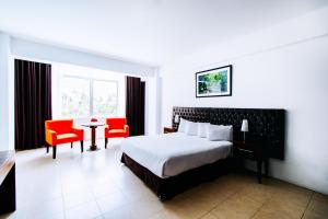 a hotel room with a bed and a table and chairs at Guizado Portillo Hacienda & Resort in Lunahuaná +80 photos