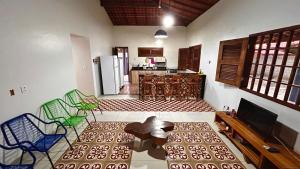 a kitchen with a table and chairs in a room at Casa Pierot in Luis Correia