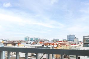 a view of a city from a balcony at ULEABO Bright Top Floor Studio in Oulu