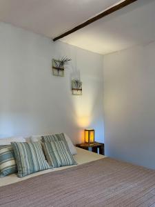 a bedroom with a bed with two pillows on it at Indiana Kite school and Hostel in Cumbuco