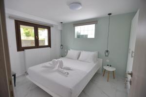 Postel nebo postele na pokoji v ubytování Theros-Cottage