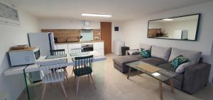 a living room with a couch and a table at La romarine in Bourg-Saint-Andéol