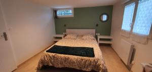 a bedroom with a bed in a room with green walls at La romarine in Bourg-Saint-Andéol