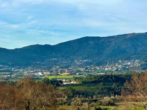 a view of a town in a mountain valley at Carmo's Boutique Hotel - Small Luxury Hotels of the World in Ponte de Lima