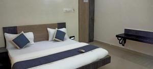 a bedroom with a large bed and a piano at Chennai Guest House in Chennai