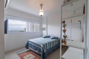 Postel nebo postele na pokoji v ubytování Apartamento com 2 Dormitórios no Coração da Praia Grande - Torres/ RS