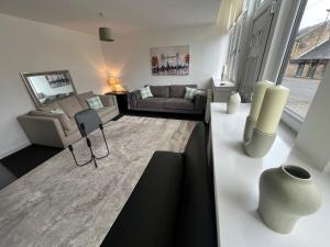 a living room with a couch and a table at The M Rooms at 144 in Kirk of Shotts