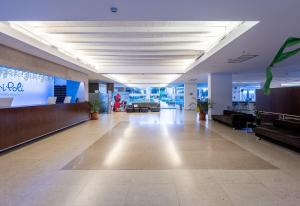 an empty lobby of an office with couches and a large screen at Atlantica Mikri Poli Kos in Kardamaina