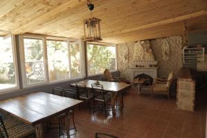 a room with tables and chairs and a fireplace at Philosophy Hotel in Uchisar