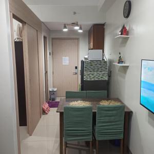 a kitchen with a table and chairs and a room at Cainta Condominium SMDC CHARM in Manila