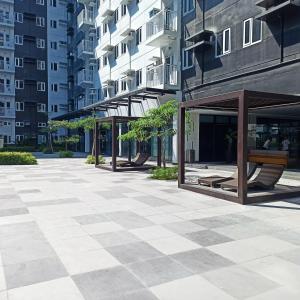 a courtyard in a city with benches and buildings at Cainta Condominium SMDC CHARM in Manila