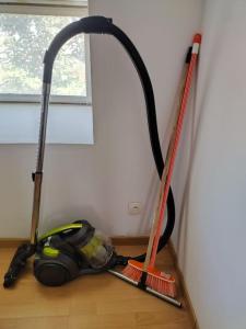 a room with two mop tools on the floor at Spacieuse et confortable maison avec garage in Anzin