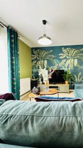 a living room with a bed and a table with flowers at Cosy apartment at the marina in Portishead