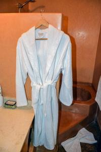 a robe is hanging on a rack in a room at Dar Tuscia in Marrakech