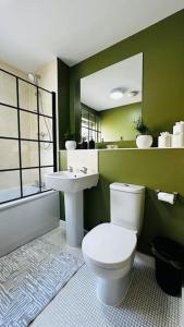 a bathroom with a white toilet and a sink at Cosy apartment at the marina in Portishead