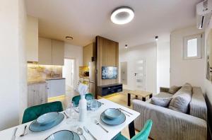 a living room with a table and a couch at Ambient apartment in Žilina