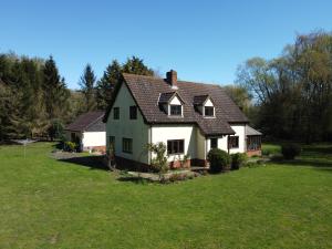 a large white house with a grass yard at Rivendell in Diss